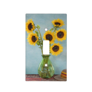 Sunflowers in vase on table light switch cover