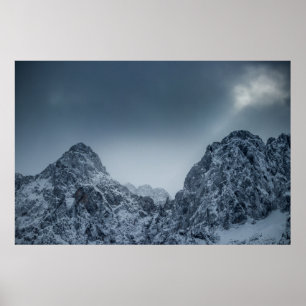 Sunlight and dark clouds over snowy mountains poster