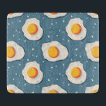 Sunny Side Up Fried Egg Pattern Cutting Board<br><div class="desc">Add a cheerful touch to your kitchen with this sunny side up fried egg pattern cutting board. The playful design features a repeating pattern of bright eggs on a textured blue background, creating a fun and modern breakfast-inspired look. Perfect for everyday food preparation or as a decorative kitchen accent, this...</div>
