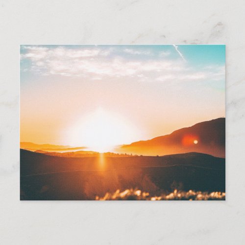 sunrise over a mountain holiday postcard