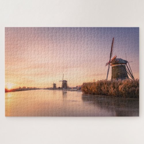 Sunrise over frozen river with windmills and reeds jigsaw puzzle