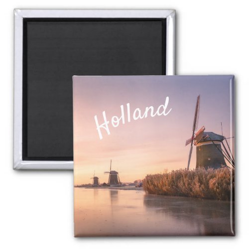 Sunrise over frozen river with windmills and reeds magnet