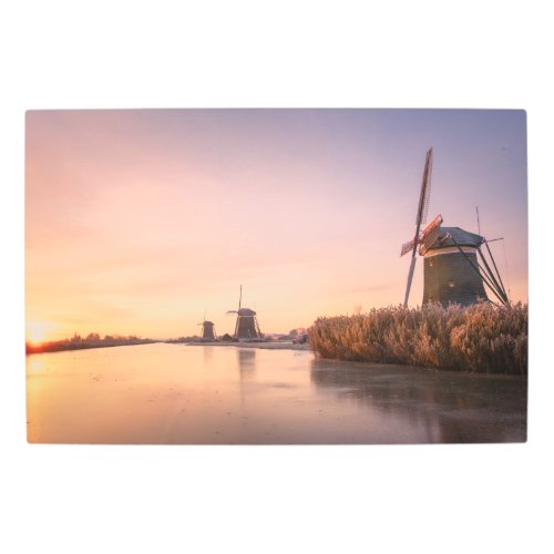 Sunrise over frozen river with windmills and reeds metal print