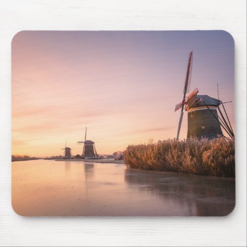 Sunrise over frozen river with windmills and reeds mouse pad