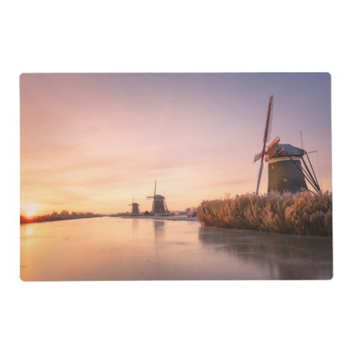 Sunrise over frozen river with windmills and reeds placemat