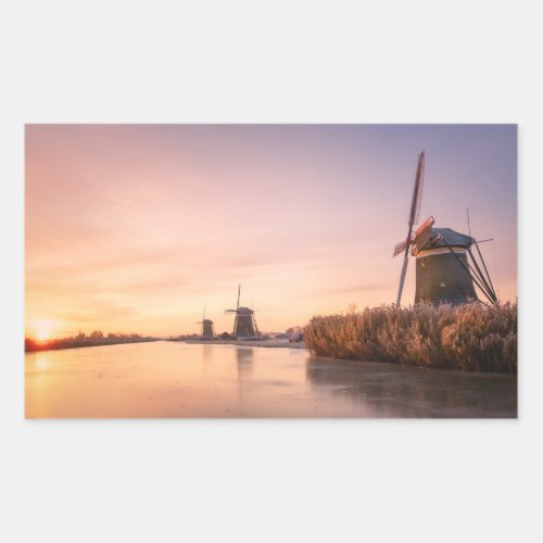 Sunrise over frozen river with windmills and reeds rectangular sticker