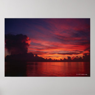 Sunset at sea with dark clouds poster