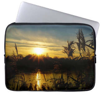 Sunset by a pond with cattails. laptop sleeve