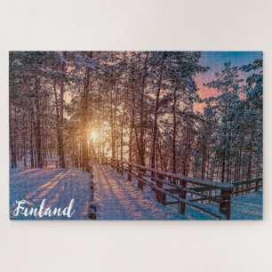 Sunset in snowy pine forest with sun ray jigsaw puzzle