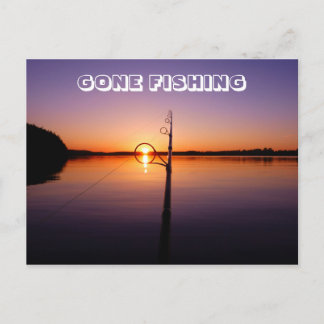 Sunset on a summer lake seen through a fishing rod postcard