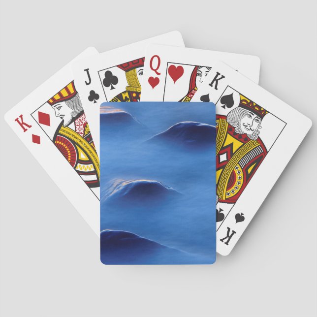 Sunset on rocks protruding through foamy water poker cards (Back)