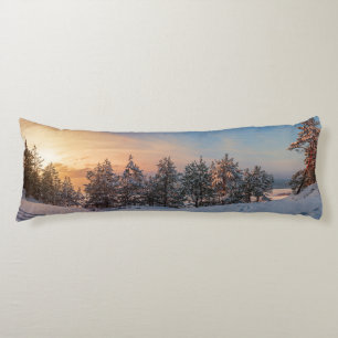Sunset over frozen snowy forest near sea body pillow