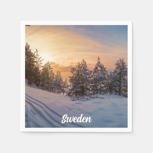 Sunset over frozen snowy forest near sea napkins