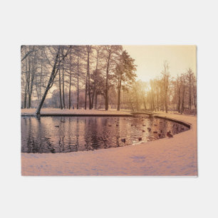 Sunset over park with small frosty lake doormat