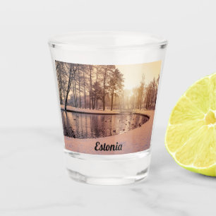 Sunset over park with small frosty lake shot glass