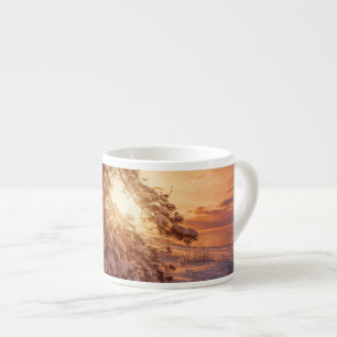 Sunset over sea and snowy pine tree espresso cup