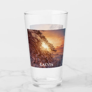 Sunset over sea and snowy pine tree glass