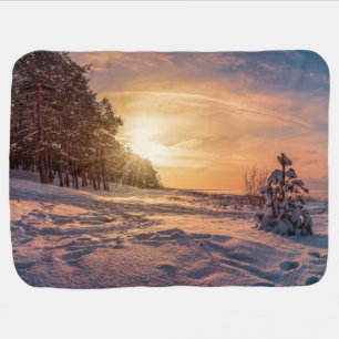 Sunset over snowy winter sea coast baby blanket