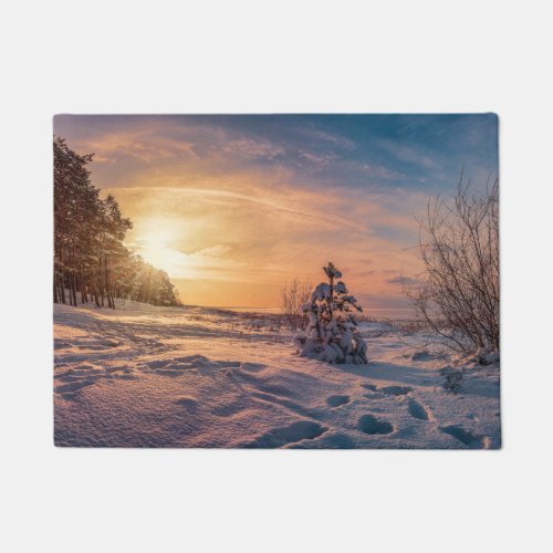 Sunset over snowy winter sea coast doormat