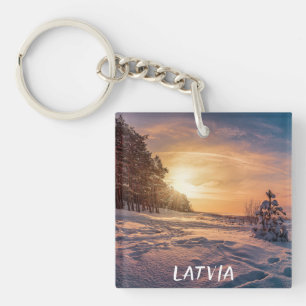 Sunset over snowy winter sea coast keychain