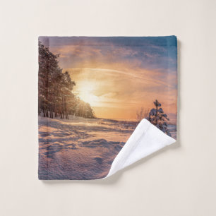 Sunset over snowy winter sea coast wash cloth