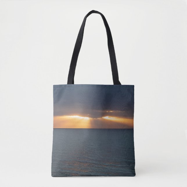 Sunset over the ocean breaking through the clouds tote bag (Front)
