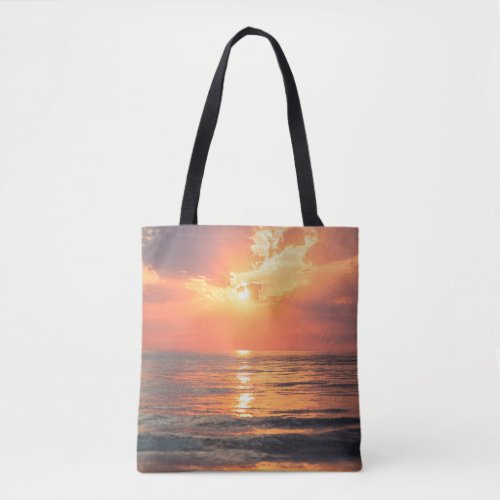 sunset over water tote bag