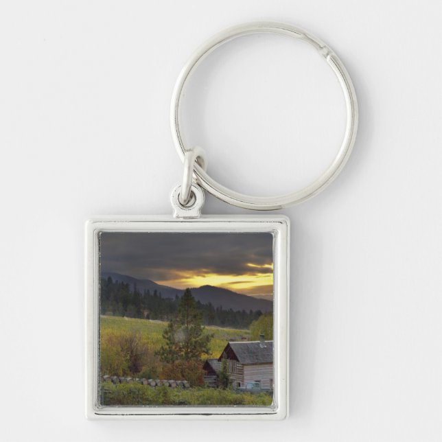 Sunset sky over vineyards and historic log cabin keychain (Front)