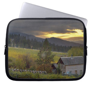 Sunset sky over vineyards and historic log cabin laptop sleeve