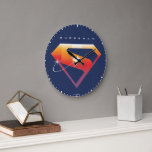 Sunset Soar Superman Shield Large Clock<br><div class="desc">Add a cosmic twist to your superhero style with this radiant Superman design! Set against a deep navy backdrop, the classic “S” shield glows in a warm gradient of fiery orange, golden yellow, and sunset pink—capturing the beauty of Superman’s power and hope. A silhouette of Superman streaks across the emblem...</div>