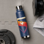 Sunset Soar Superman Shield Water Bottle<br><div class="desc">Add a cosmic twist to your superhero style with this radiant Superman design! Set against a deep navy backdrop, the classic “S” shield glows in a warm gradient of fiery orange, golden yellow, and sunset pink—capturing the beauty of Superman’s power and hope. A silhouette of Superman streaks across the emblem...</div>