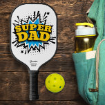 Super Dad Comic Strip Action Bubble, Custom Text Pickleball Paddle<br><div class="desc">Super Dad, super hero or super pickler - he's probably all three! Fun pickleball paddle featuring a comic strip action bubble that reads "Super Dad" and 2 lines of custom text - add your name, pickleball club name, company name, location, phone number, etc. Perfect as a Father's Day or birthday...</div>