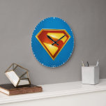 Superman Golden S Shield Brilliance Large Clock<br><div class="desc">Shine bright with the legendary symbol of hope! This stunning design features the iconic Superman “S” shield rendered in radiant gold and deep crimson, glowing with heroic intensity against a bold blue background. The sleek metallic finish and rich color gradients give this emblem a powerful, modern edge—perfect for fans who...</div>