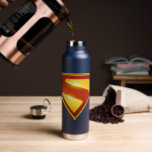 Superman Golden S Shield Brilliance Water Bottle<br><div class="desc">Shine bright with the legendary symbol of hope! This stunning design features the iconic Superman “S” shield rendered in radiant gold and deep crimson, glowing with heroic intensity against a bold blue background. The sleek metallic finish and rich color gradients give this emblem a powerful, modern edge—perfect for fans who...</div>