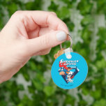 Superman & Krypto Soar Keychain<br><div class="desc">Get ready for double the heroics with this action-packed design featuring Superman and his super-powered pup, Krypto! Bursting out of the classic “S” shield backdrop with the Metropolis skyline behind them, this dynamic duo is all smiles (and capes) as they rocket into action. Superman leads with his iconic red and...</div>