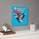 Superman & Krypto Soar Square Wall Clock<br><div class="desc">Get ready for double the heroics with this action-packed design featuring Superman and his super-powered pup, Krypto! Bursting out of the classic “S” shield backdrop with the Metropolis skyline behind them, this dynamic duo is all smiles (and capes) as they rocket into action. Superman leads with his iconic red and...</div>