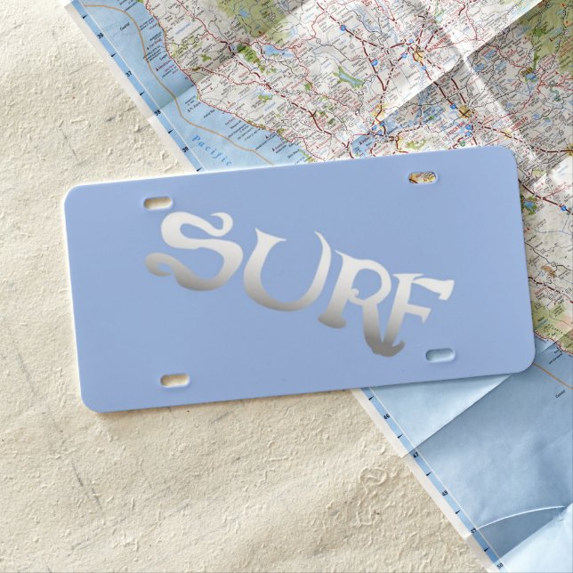 Surf tilted blue plastic car license plate (In Situ)