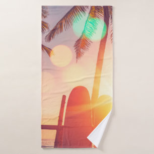 Surfboard and palm tree on beach double exposure w bath towel