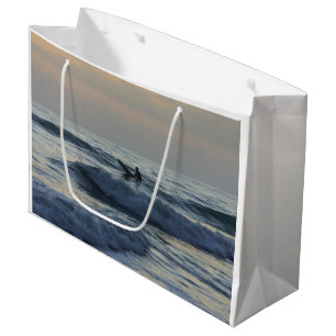 Surfer Awaits Large Gift Bag