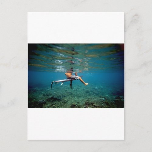 Surfer sitting on surfboard over coral reef postcard