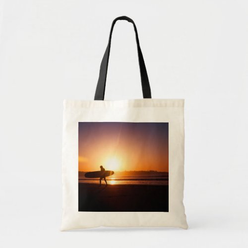 Surfer with Surfboard on Beach at Sunset Tote Bag