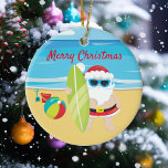 Surfing Beach Santa Tropical Ceramic Ornament<br><div class="desc">This design was created though digital art. It may be personalized in the area provided or customizing by changing the photo or added your own words. Contact me at colorflowcreations@gmail.com if you with to have this design on another product. Purchase my original abstract acrylic painting for sale at www.etsy.com/shop/colorflowart. See...</div>