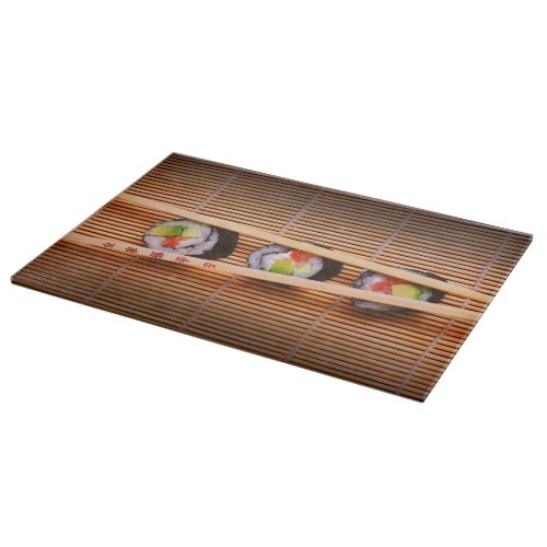 Sushi and wooden chopsticks cutting board