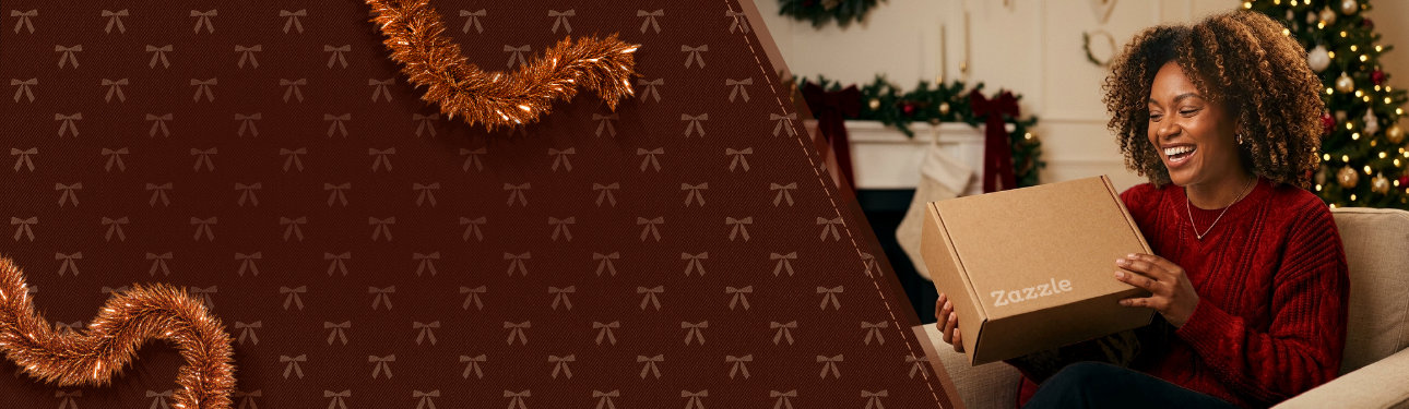 Woman opening a Zazzle package by a decorated Christmas tree.