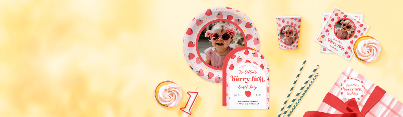 Birthday party supplies to celebrate a 1st birthday, including an invitation, napkins, plates and paper cups