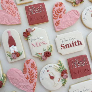 A beautiful spread of red and white cookies for a bridal shower.