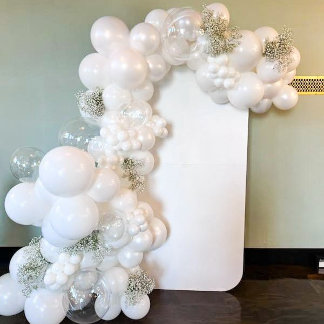 White balloons next to a blank white sign. 