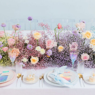 Beautiful pastel wildflowers decorate a themed table spread.