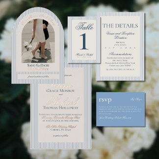A collection of striped wedding paper goods in soft neutrals is arranged in a structured flat lay. Vertical lines create a polished, symmetrical look. Minimalist typography enhances the refined mood. The aesthetic is clean, classic, and gently elevated.