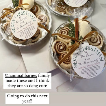 Cinnamon rolls boxed as gifts, tied with brown ribbon and round "Merry Christmas" kraft tags. Homemade, rustic, thoughtful-giving styling.